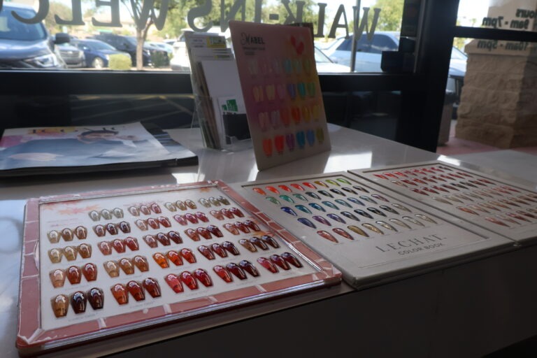 Gel polish and acrylic nail color display rack in Gilbert nail salon